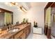 Bathroom with vanity, granite countertop, decorative mirrors, and tiled shower at 429 Kimberly Ct, Sanford, FL 32771