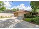 Charming home featuring an attached two-car garage, beautiful landscaping, and paved driveway at 429 Kimberly Ct, Sanford, FL 32771