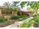 Attractive brick home with lush landscaping and a welcoming walkway to the front door at 429 Kimberly Ct, Sanford, FL 32771
