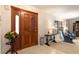 Inviting foyer with hardwood door, tile flooring, and a view into the living area at 429 Kimberly Ct, Sanford, FL 32771