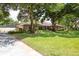 Well-maintained brick house with lush green lawn, mature trees, and long driveway at 429 Kimberly Ct, Sanford, FL 32771