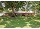 Charming brick home featuring a well-manicured lawn and mature trees providing shade at 429 Kimberly Ct, Sanford, FL 32771