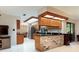Bright kitchen featuring wood cabinets, granite countertops, and brick accents at 429 Kimberly Ct, Sanford, FL 32771