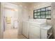 Bright laundry room with tile flooring, washer, dryer, and adjacent bathroom at 429 Kimberly Ct, Sanford, FL 32771
