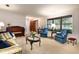 Warm living room featuring plush blue chairs and a large window at 429 Kimberly Ct, Sanford, FL 32771
