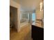 Bathroom with dual vanity, granite counters, separate shower and tub at 4920 E Lake Cove Blvd, St Cloud, FL 34771