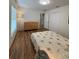 Bedroom featuring wood floors, a closet, and a queen-sized bed with neutral-colored walls at 4920 E Lake Cove Blvd, St Cloud, FL 34771