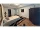 Cozy bedroom featuring a comfortable bed, tray ceiling, and wood laminate flooring at 4920 E Lake Cove Blvd, St Cloud, FL 34771