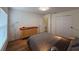 Cozy bedroom with hardwood floors, closet, dresser, and neutral wall paint at 4920 E Lake Cove Blvd, St Cloud, FL 34771