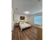Bedroom with wood floors, a queen-sized bed, a window, and neutral-colored walls at 4920 E Lake Cove Blvd, St Cloud, FL 34771