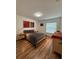 Bedroom featuring wood floors, a colorful side table, and neutral colored bedding at 4920 E Lake Cove Blvd, St Cloud, FL 34771