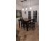 Dining area with a square table and four chairs near white french doors, bathed in natural light at 4920 E Lake Cove Blvd, St Cloud, FL 34771