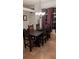 Dining room with an elegant chandelier, a dark wood table, and windows with striped curtains at 4920 E Lake Cove Blvd, St Cloud, FL 34771