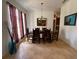 Spacious dining room with tile floors, large window, and elegant light fixture at 4920 E Lake Cove Blvd, St Cloud, FL 34771