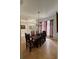 Charming dining room features dark wood table and chairs, as well as striped window treatments at 4920 E Lake Cove Blvd, St Cloud, FL 34771