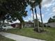 Charming single-Gathering home featuring a well-manicured lawn, mature trees, and a two-car garage at 4920 E Lake Cove Blvd, St Cloud, FL 34771