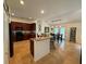 Open-concept kitchen with a breakfast bar, tile flooring, and stainless steel appliances at 4920 E Lake Cove Blvd, St Cloud, FL 34771