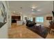 Open-concept living room with tile floors, kitchen access, and ample natural light at 4920 E Lake Cove Blvd, St Cloud, FL 34771