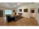 Inviting living room featuring tiled floors, a comfortable sofa, and large windows for natural light at 4920 E Lake Cove Blvd, St Cloud, FL 34771