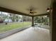 Enclosed back patio with ceiling fan and outdoor seating overlooking a lush backyard at 4920 E Lake Cove Blvd, St Cloud, FL 34771