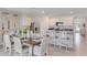 Open-concept dining area featuring modern table set for eight adjacent to kitchen at 5063 Tana Ter, St Cloud, FL 34772