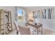 Bright home office with neutral tones, a modern desk, and a window providing natural light for productivity at 5063 Tana Ter, St Cloud, FL 34772