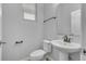 Well-lit half bathroom with modern fixtures, a pedestal sink, and tile floors at 5118 Adelaide Dr, Kissimmee, FL 34746