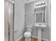 Updated bathroom includes a glass shower, pedestal sink, and tile floors at 5118 Adelaide Dr, Kissimmee, FL 34746