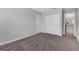 Neutral bedroom featuring gray walls, gray carpet, closet, and a bathroom view at 5118 Adelaide Dr, Kissimmee, FL 34746