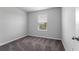 Neutral bedroom features gray carpet and a large window at 5118 Adelaide Dr, Kissimmee, FL 34746