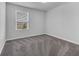 Bright bedroom with neutral carpet and a large window with blinds at 5118 Adelaide Dr, Kissimmee, FL 34746