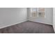 Cozy bedroom features neutral paint, plush carpet, and natural light from the windows at 5118 Adelaide Dr, Kissimmee, FL 34746