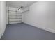 Clean garage space with epoxy floor, white walls, and an aluminum door at 5118 Adelaide Dr, Kissimmee, FL 34746