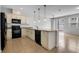 Open-concept kitchen boasts granite countertops, black appliances, pendant lighting, and tile floors at 5118 Adelaide Dr, Kissimmee, FL 34746