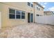 Paver patio and fenced backyard of home with sliding door entrance at 5118 Adelaide Dr, Kissimmee, FL 34746