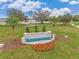 Scenic community entrance with lush landscaping, a tiled water feature, and neighborhood sign at 5133 Masser Rd, St Cloud, FL 34772