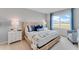 Relaxing main bedroom boasts a beachy color scheme, a plush bed, and a large window at 5133 Masser Rd, St Cloud, FL 34772