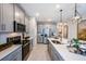 Modern kitchen featuring stainless appliances, grey cabinetry and a large kitchen island at 540 Southern Edge Way, Sanford, FL 32771