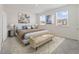 Bright primary bedroom with two windows, neutral decor, and a comfortable queen-sized bed at 555 Southern Edge Way, Sanford, FL 32771