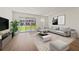 Bright living room with a large sliding glass door, a comfortable sofa, and stylish décor at 555 Southern Edge Way, Sanford, FL 32771
