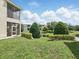The backyard features a screened-in porch, lush green grass, a small pond and hedges at 7021 Della Dr # 51, Orlando, FL 32819
