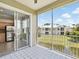 Outdoor balcony area, adjacent to kitchen, overlooking scenic neighborhood, and nearby pond at 7021 Della Dr # 51, Orlando, FL 32819