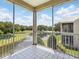 Balcony with a screened-in enclosure overlooking a pond and trees at 7021 Della Dr # 51, Orlando, FL 32819