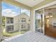 Balcony with tiled floor and screened enclosure with view of building and yard at 7021 Della Dr # 51, Orlando, FL 32819
