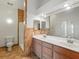 Modern bathroom featuring double sinks, a large mirror, and a tiled shower with glass door at 7021 Della Dr # 51, Orlando, FL 32819