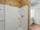 Modern bathroom with a tiled shower featuring glass doors, a built-in seat, and storage shelves at 7021 Della Dr # 51, Orlando, FL 32819