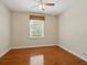 Well-lit bedroom with hardwood floors and large window allowing for natural light at 7021 Della Dr # 51, Orlando, FL 32819