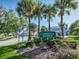 Welcome to Carriage Homes sign surrounded by mature landscaping and lush greenery at 7021 Della Dr # 51, Orlando, FL 32819