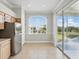 Bright dining area with tile flooring, a slider door to the balcony, and a view of the pond at 7021 Della Dr # 51, Orlando, FL 32819
