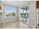 Bright dining area with tile flooring, large window, and sliding door to screened balcony at 7021 Della Dr # 51, Orlando, FL 32819